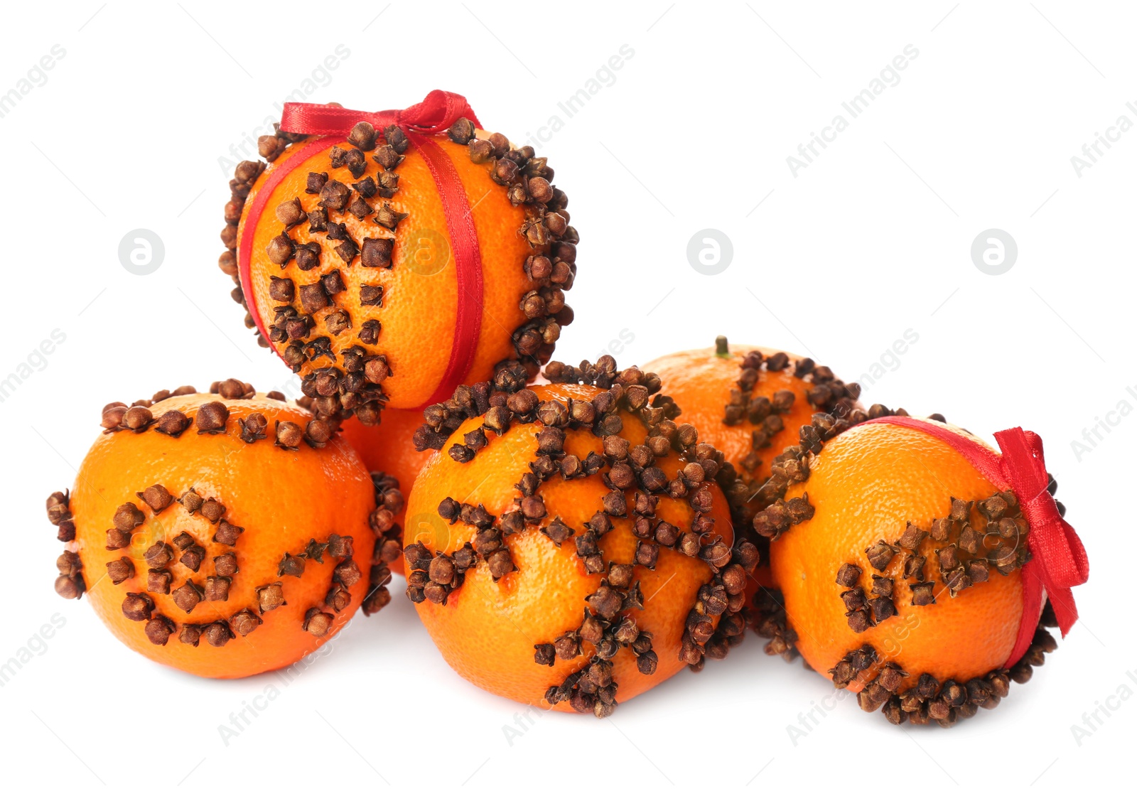 Photo of Pile of pomander balls made of fresh tangerines with cloves on white background