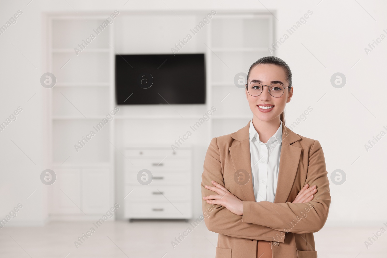 Photo of Happy real estate agent in new apartment. Space for text