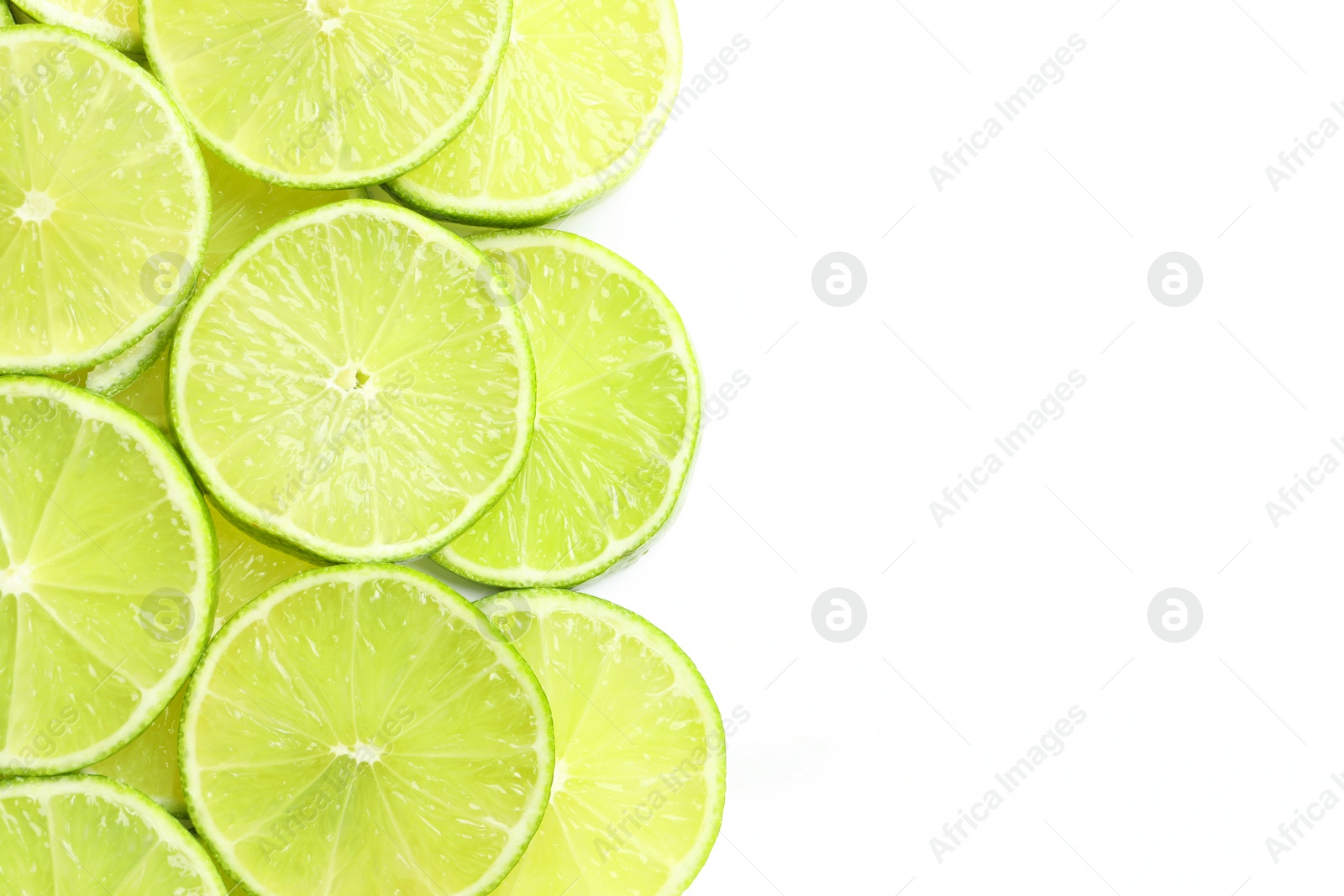 Photo of Fresh juicy lime slices on white background, flat lay. Space for text