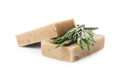 Handmade soap bars and rosemary on white background