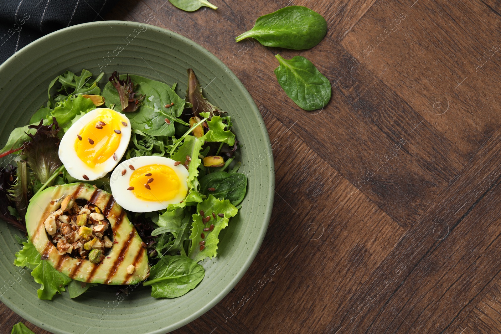 Photo of Healthy dish high in vegetable fats on wooden table, top view. Space for text