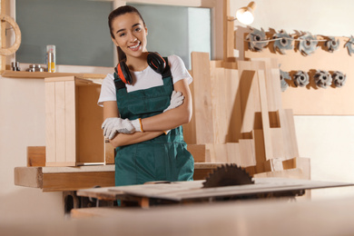 Photo of Professional female carpenter in uniform near workbench