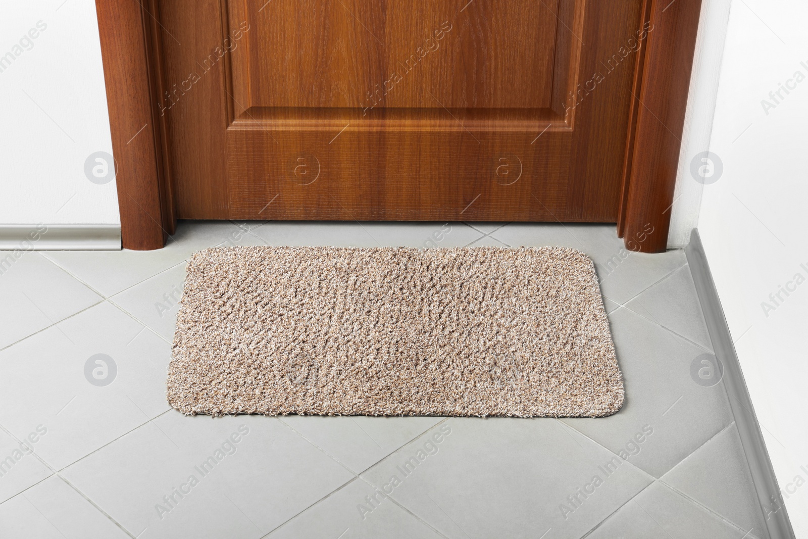 Photo of Clean door mat on floor near entrance