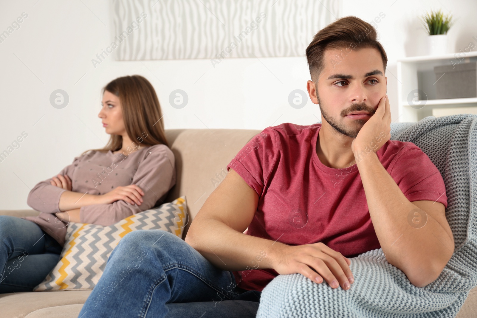 Photo of Young couple with relationship problems in living room