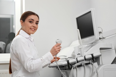 Photo of Professional sonographer using modern ultrasound machine in clinic