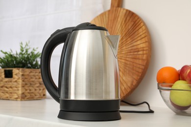 Modern electric kettle on counter in kitchen