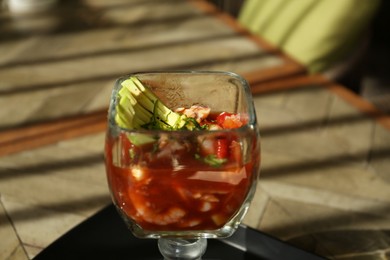 Photo of Delicious campechana cocktail with shrimps on table, closeup