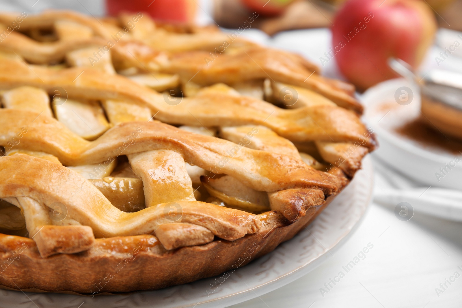 Photo of Delicious traditional apple pie on white table, closeup