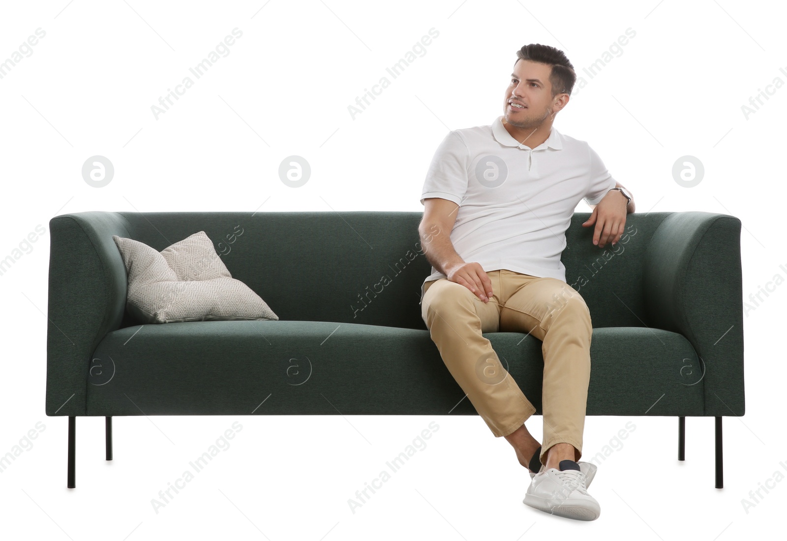 Photo of Man relaxing on comfortable green sofa against white background