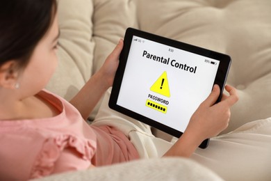 Photo of Little girl having access restriction by parental control on tablet, closeup. Child safety