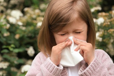 Little girl suffering from seasonal pollen allergy on spring day