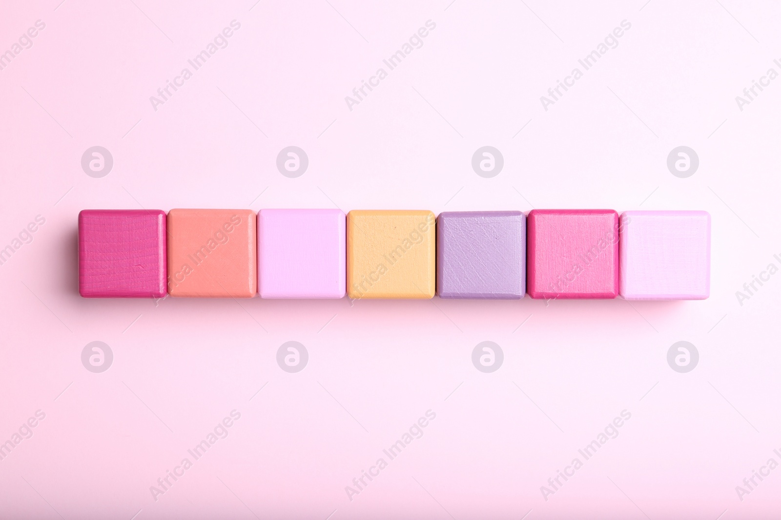 Photo of Colorful cubes with word KEYWORD on pink background, flat lay