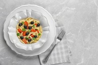 Tasty pasta salad with vegetables on table