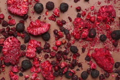 Chocolate bar with freeze dried berries as background, closeup