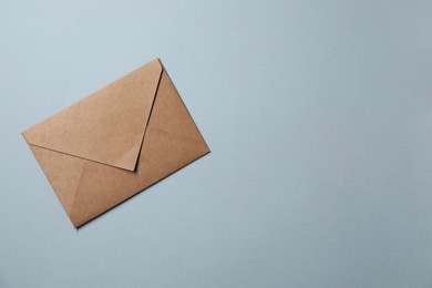 Photo of Letter envelope on grey background, top view. Space for text