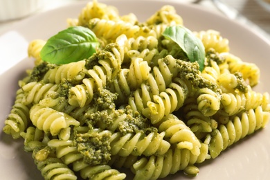 Delicious basil pesto pasta on plate, closeup