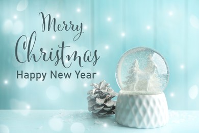Image of Merry Christmas and Happy New Year. Beautiful snow globe and fir cone on light blue background, bokeh effect