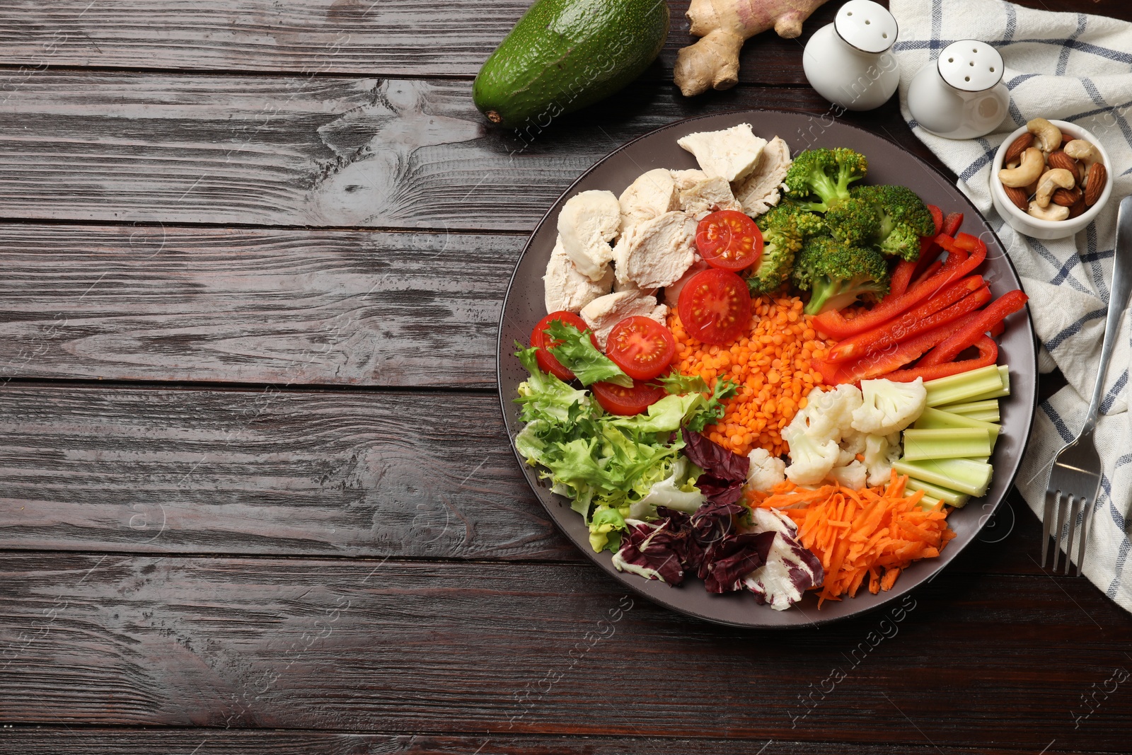 Photo of Balanced diet and healthy foods. Plate with different delicious products on dark wooden table, flat lay. Space for text