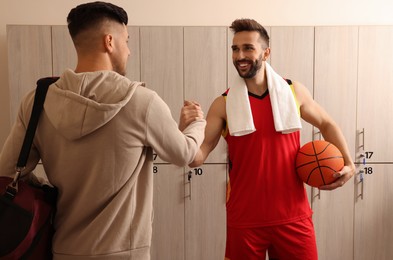 Handsome men greeting each other in locker room