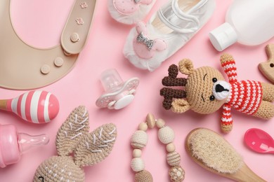 Photo of Flat lay composition with pacifier and other baby stuff on pink background