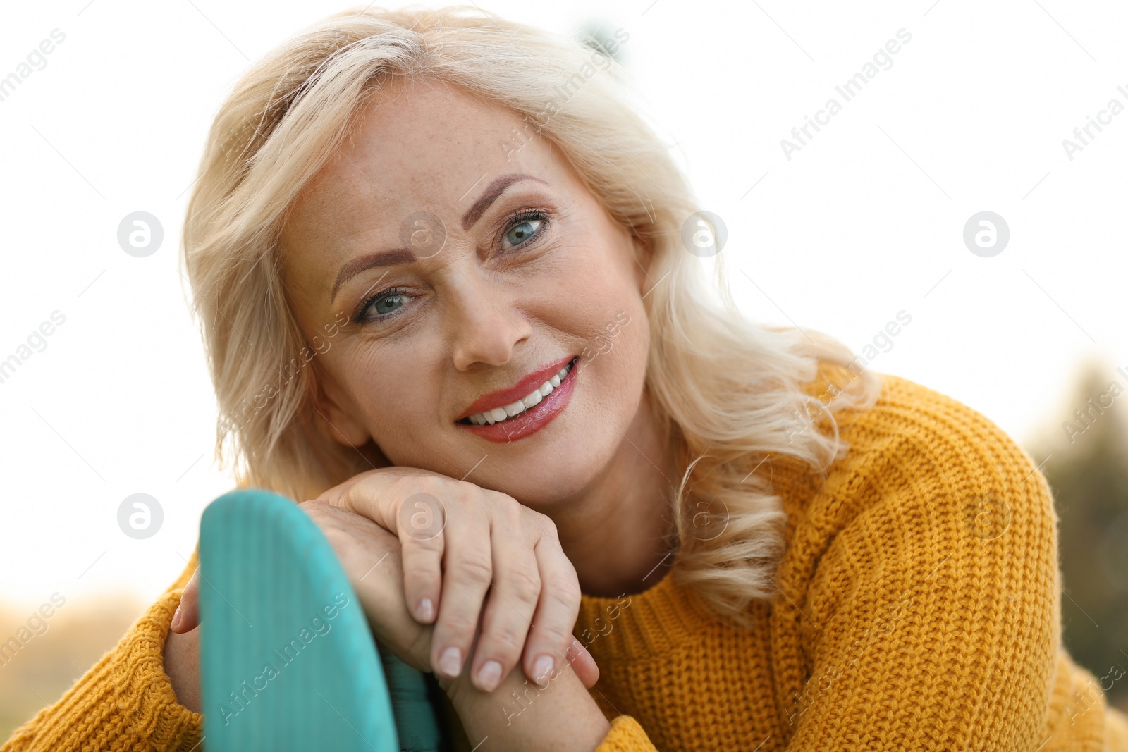 Photo of Portrait of happy mature woman in park