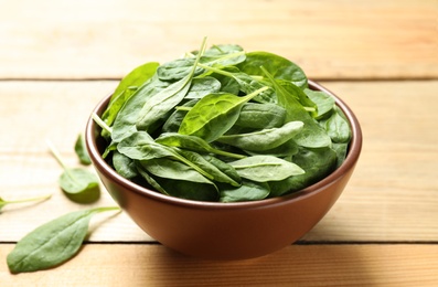 Photo of Fresh green healthy spinach on wooden table