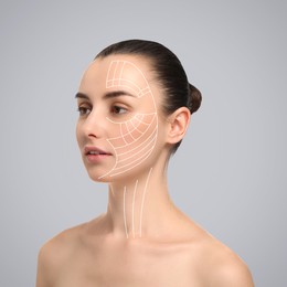 Attractive woman with perfect skin after cosmetic treatment on grey background. Lifting arrows on her face