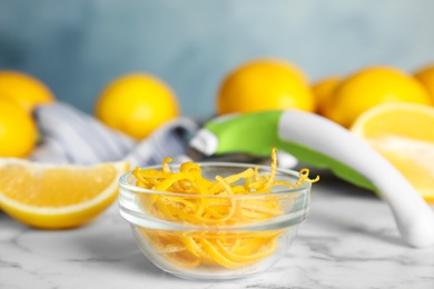 Photo of Lemon zest and fresh fruits on white marble table