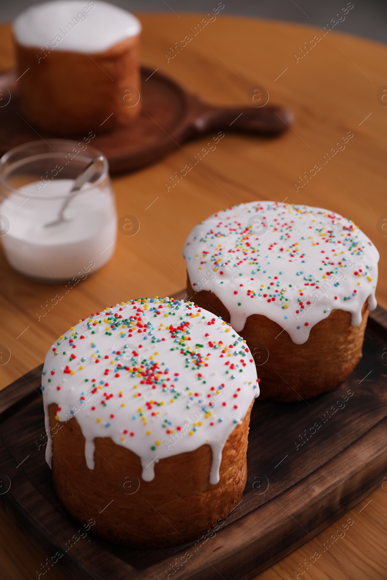 Photo of Traditional Easter cakes on wooden table, closeup. Space for text