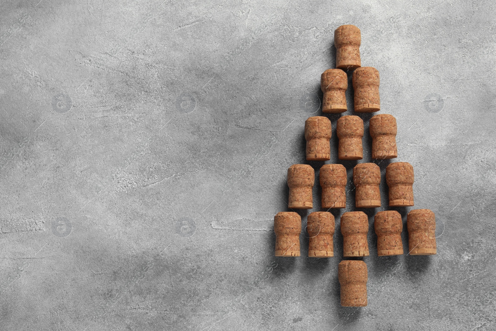 Photo of Christmas tree made of wine corks on grey table, top view. Space for text