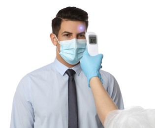 Image of Doctor measuring man's temperature on white background, closeup. Prevent spreading of Covid-19