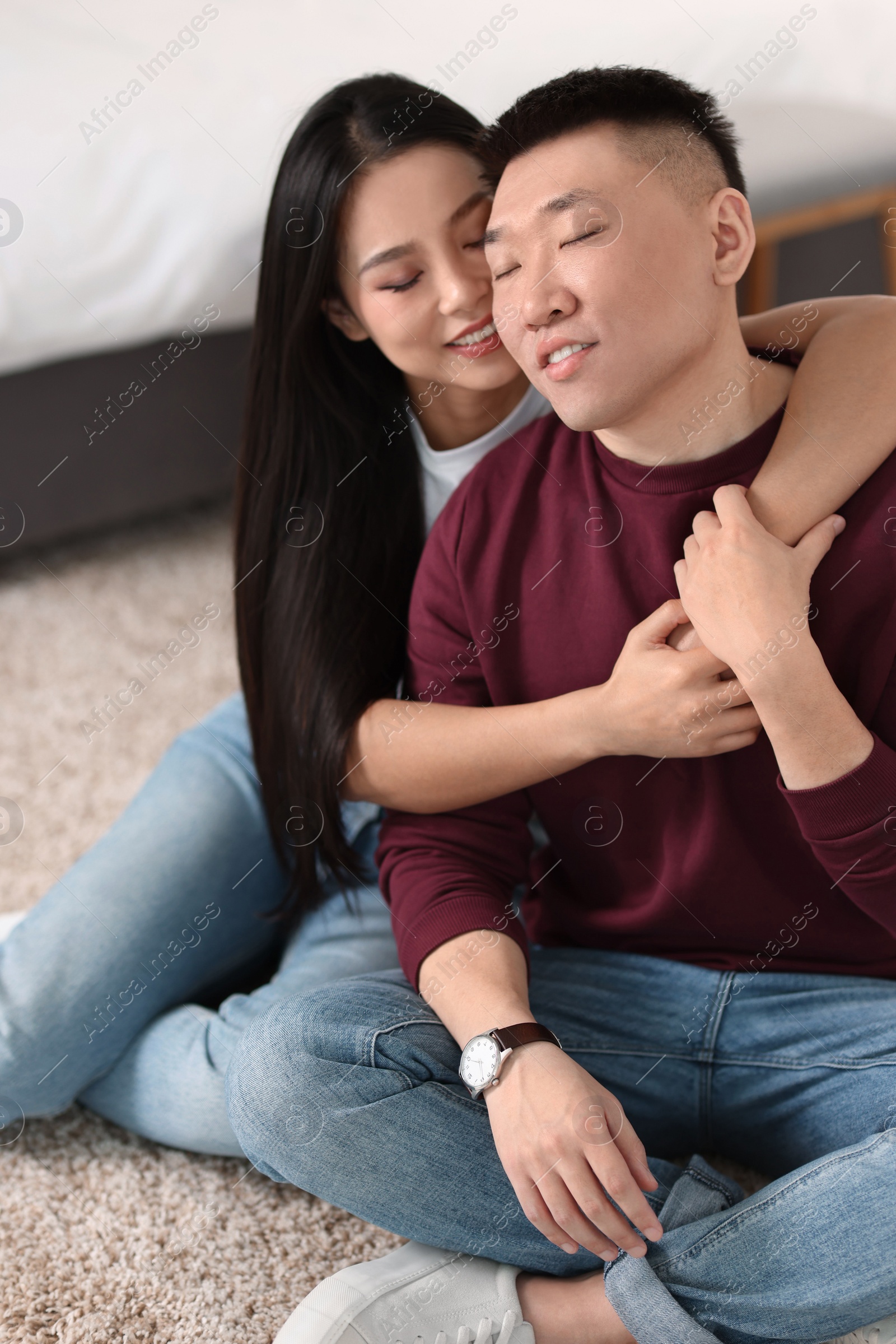 Photo of Lovely young couple on floor at home