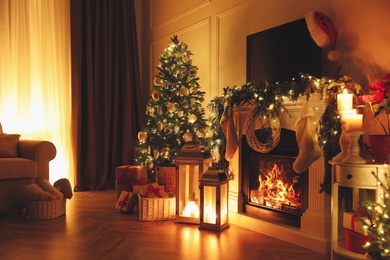 Beautiful room interior with fireplace and Christmas decor in evening