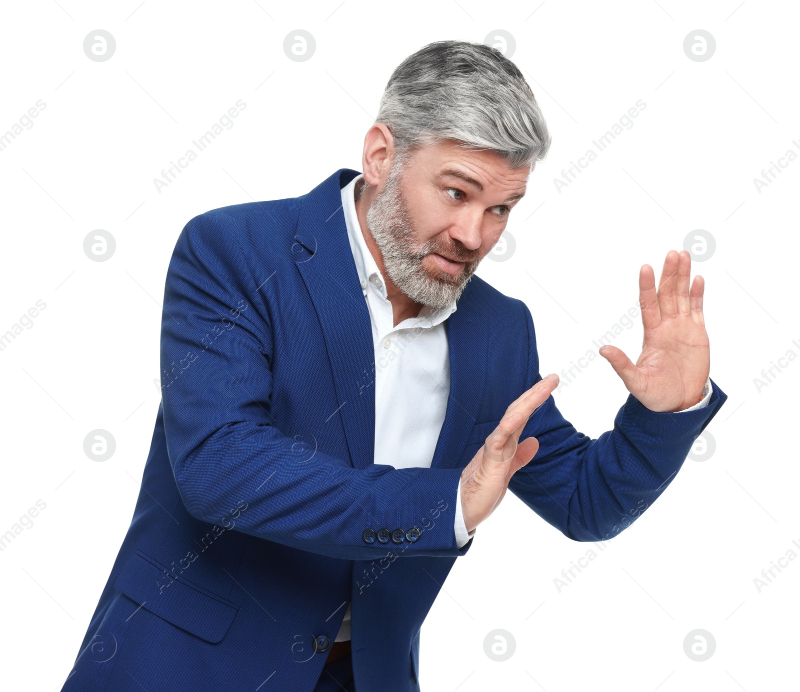 Photo of Mature businessman in stylish clothes avoiding something on white background