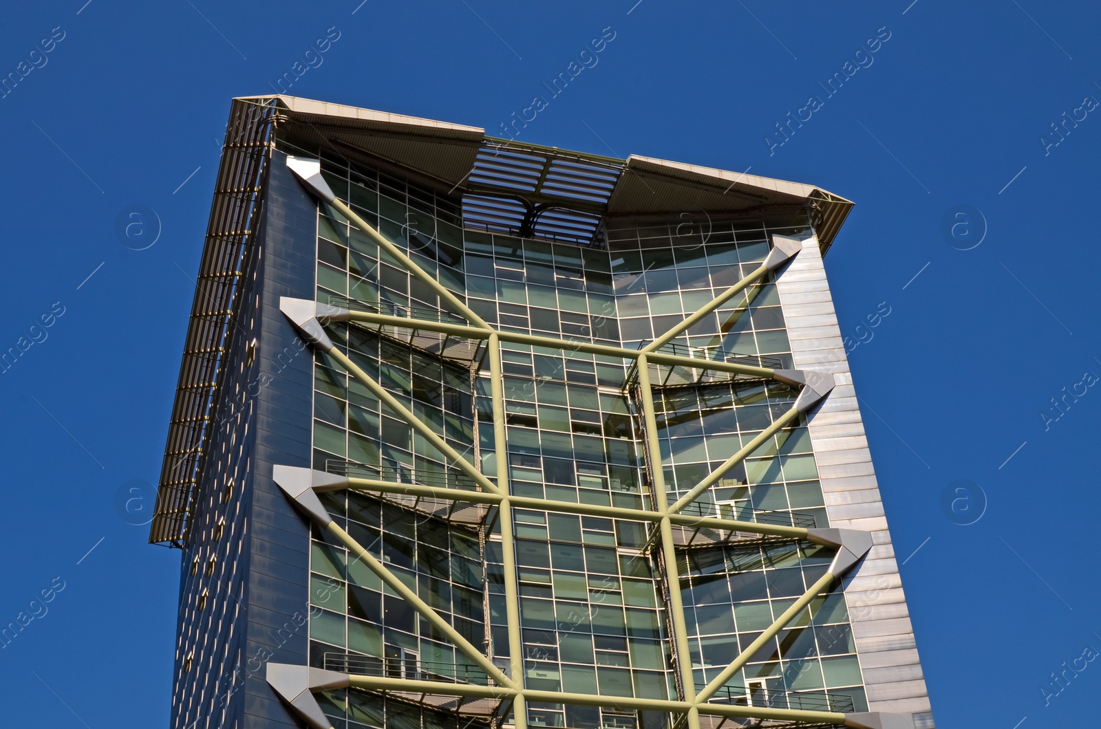 Photo of Exterior of beautiful modern building against blue sky, low angle view