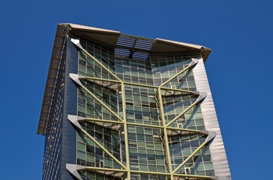 Exterior of beautiful modern building against blue sky, low angle view