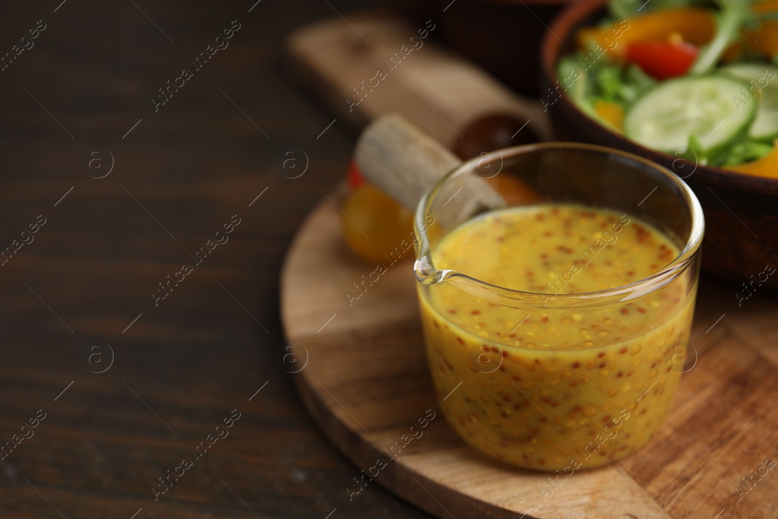 Photo of Tasty vinegar based sauce (Vinaigrette) on wooden table, closeup. Space for text