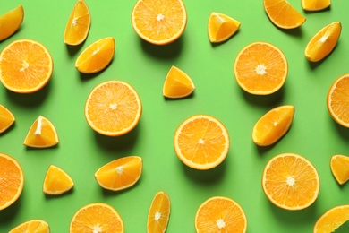 Flat lay composition with ripe oranges on color background