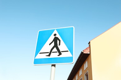 Photo of Traffic sign Pedestrian Crossing against blue sky, low angle view