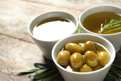 Photo of Bowl with ripe olives in oil, closeup