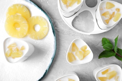 Photo of Flat lay composition with pineapple yogurt and ingredients on table. Multi cooker recipe