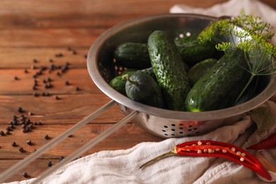 Photo of Fresh cucumbers, dill, garlic and pepper on wooden table. Pickling recipe