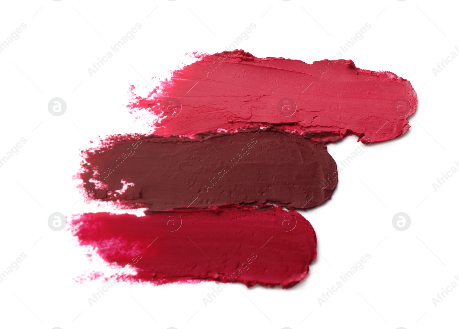 Photo of Smears of beautiful lipsticks on white background, top view