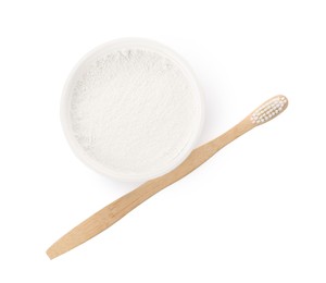 Bowl of tooth powder and brush on white background, top view