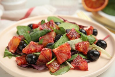 Photo of Delicious salad with sicilian orange on white table, closeup