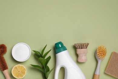 Photo of Flat lay composition with different cleaning supplies on green background, space for text