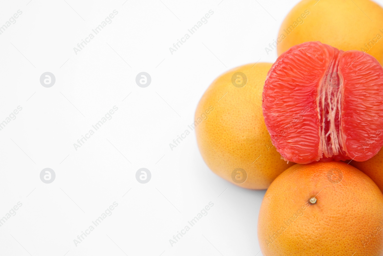 Photo of Many fresh grapefruits on white background, above view. Space for text