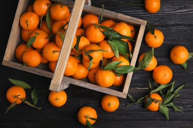 Photo of Flat lay composition with fresh ripe tangerines on wooden background