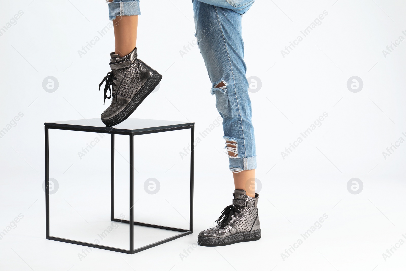 Photo of Woman in stylish shoes and stand on white background, closeup