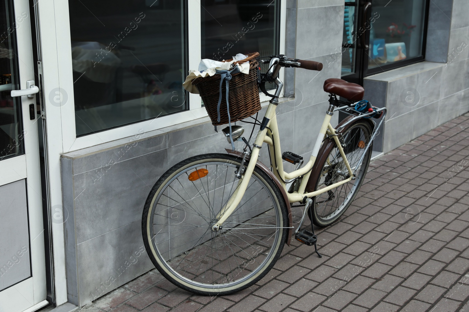 Photo of Vintage bicycle with basket near shop entrance